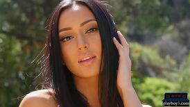 Beautiful exotic and slim Playboy model stripteasing outdoor